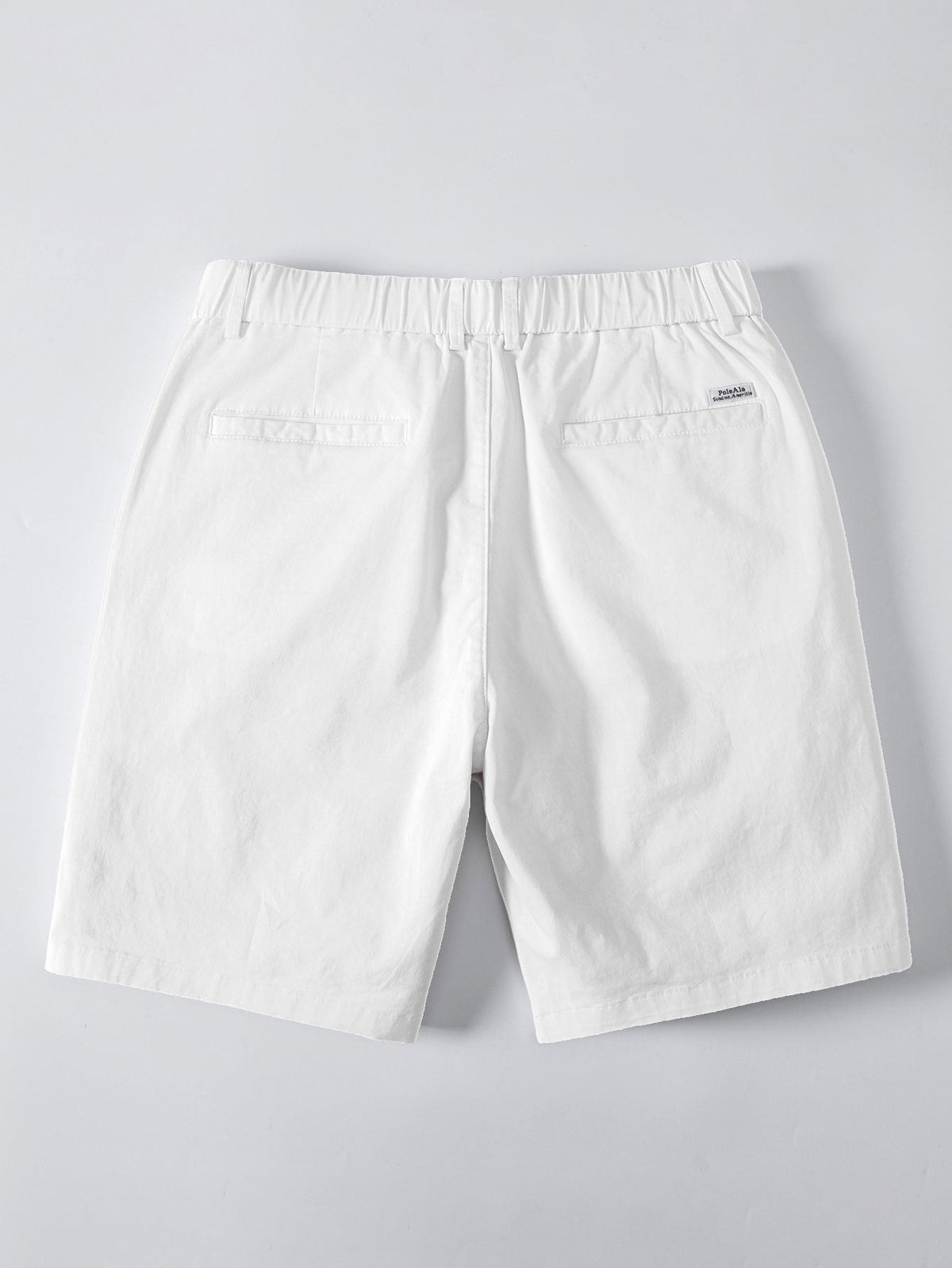 Valkoiset chino-shortsit joustavalla vyötäröllä takaa